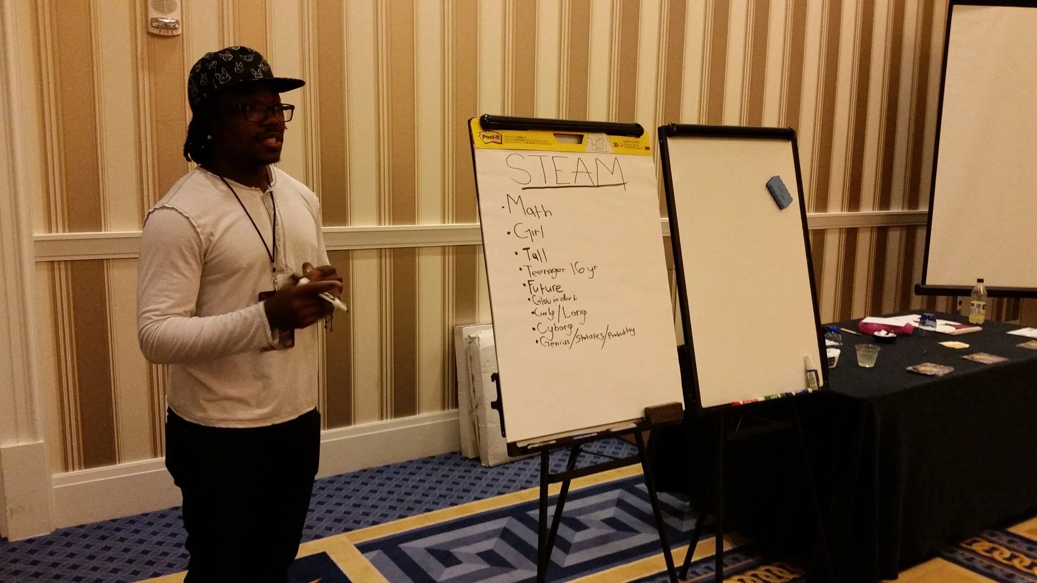 Darren Soto teaches students to make a character inspired by select words. 