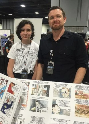 A student smiles with Evan Keeling (right)