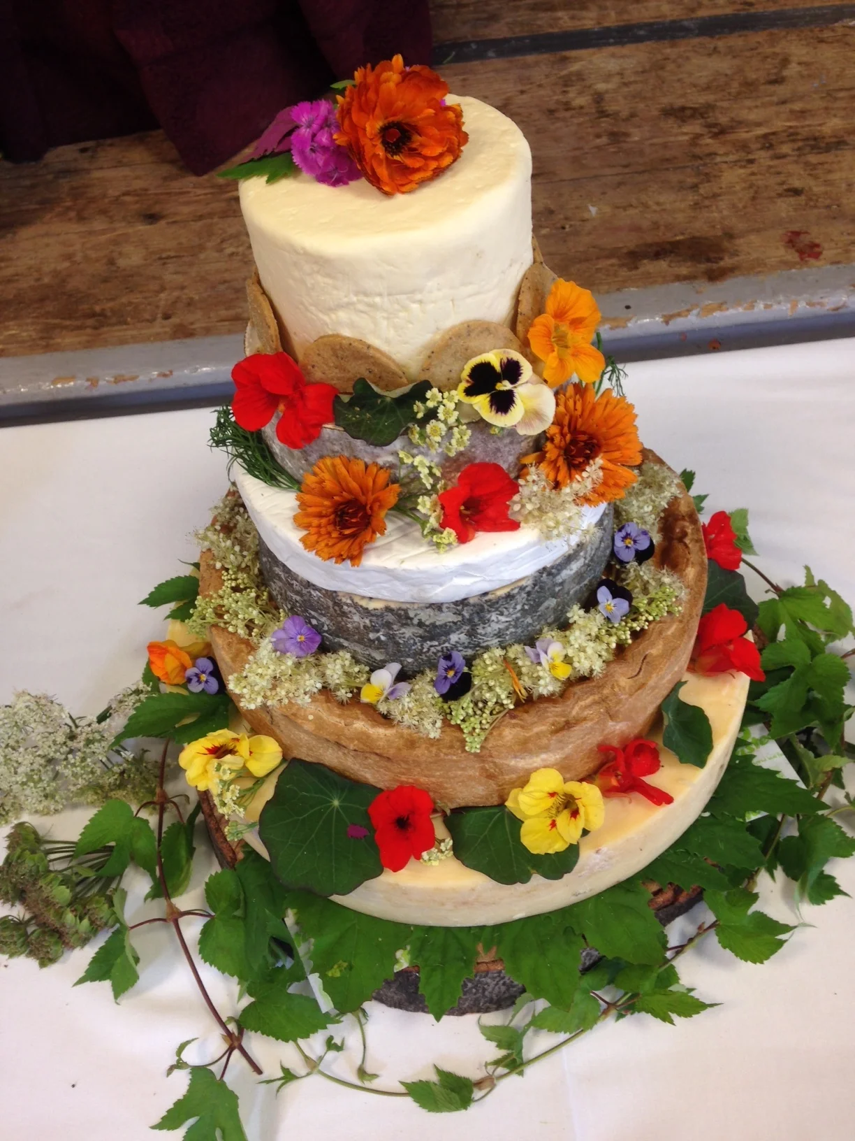 A Wedding Cake of Cheese (supplied by Reece at Urban Pantry ) decorated with hop (dwarf variety Prima Donna), Marigold ,Viola, Nasturium, Borage and foraged Meadowsweet
