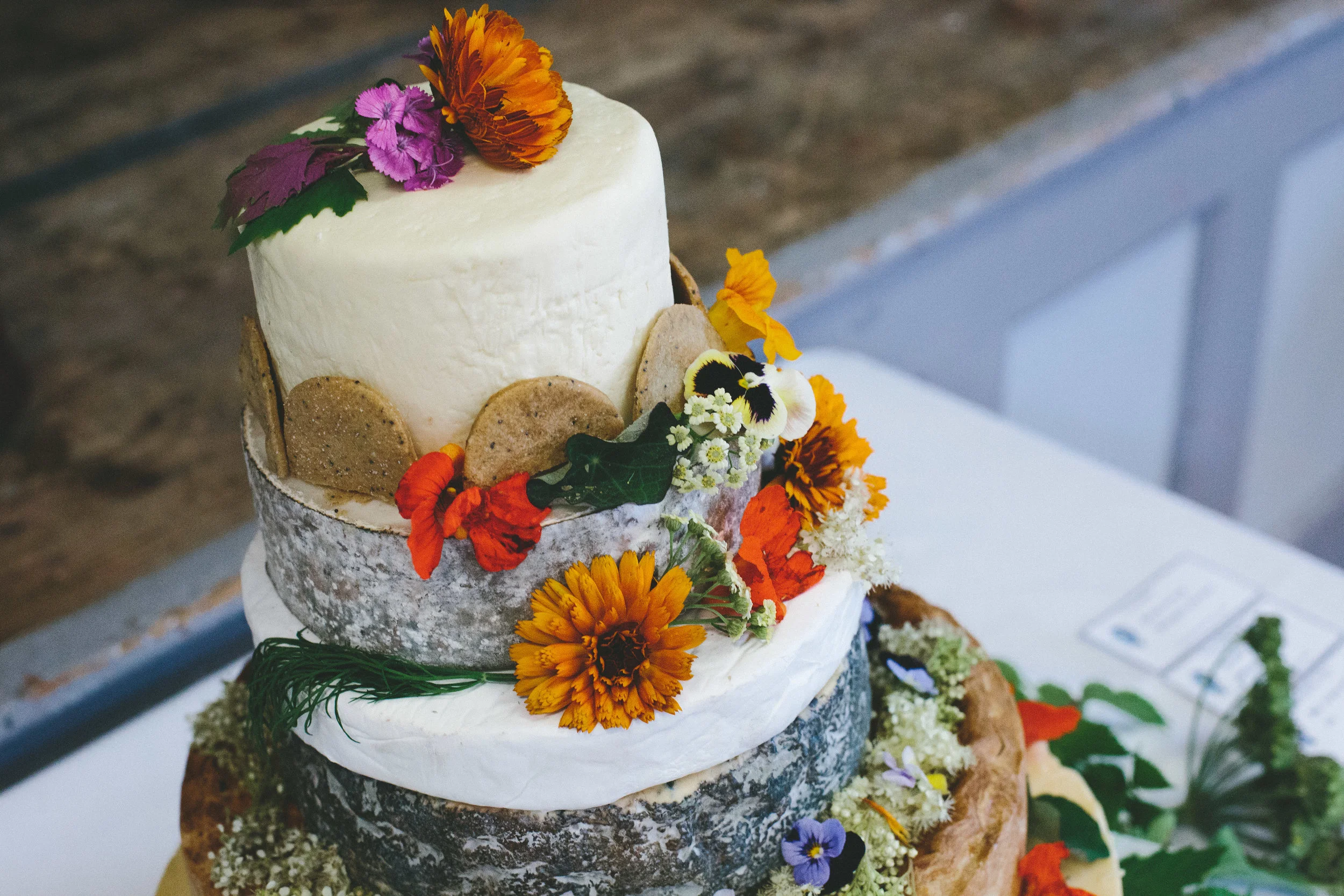 Whole Marigolds decorating this cake of cheese