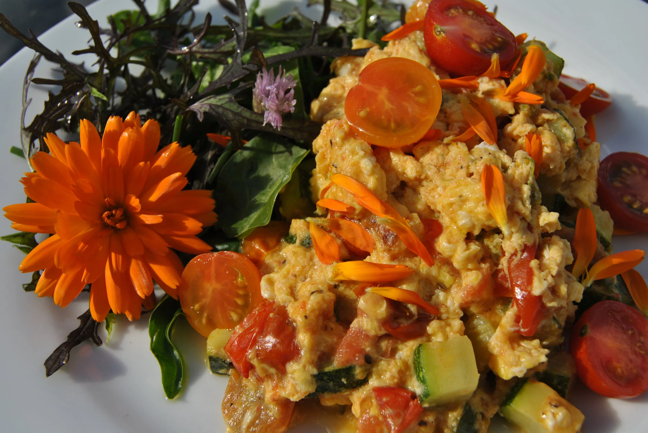 Sunny scrambled eggs with garden vegetables and salad and Marigold "petals"