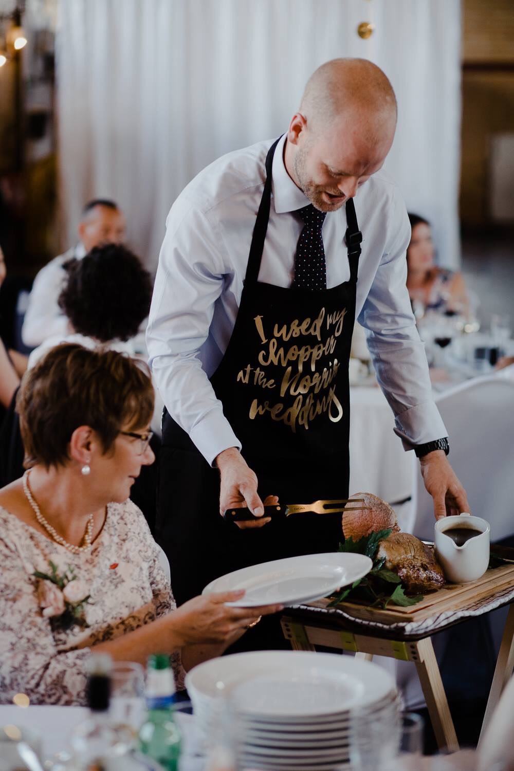 The Groom's father carving at the table