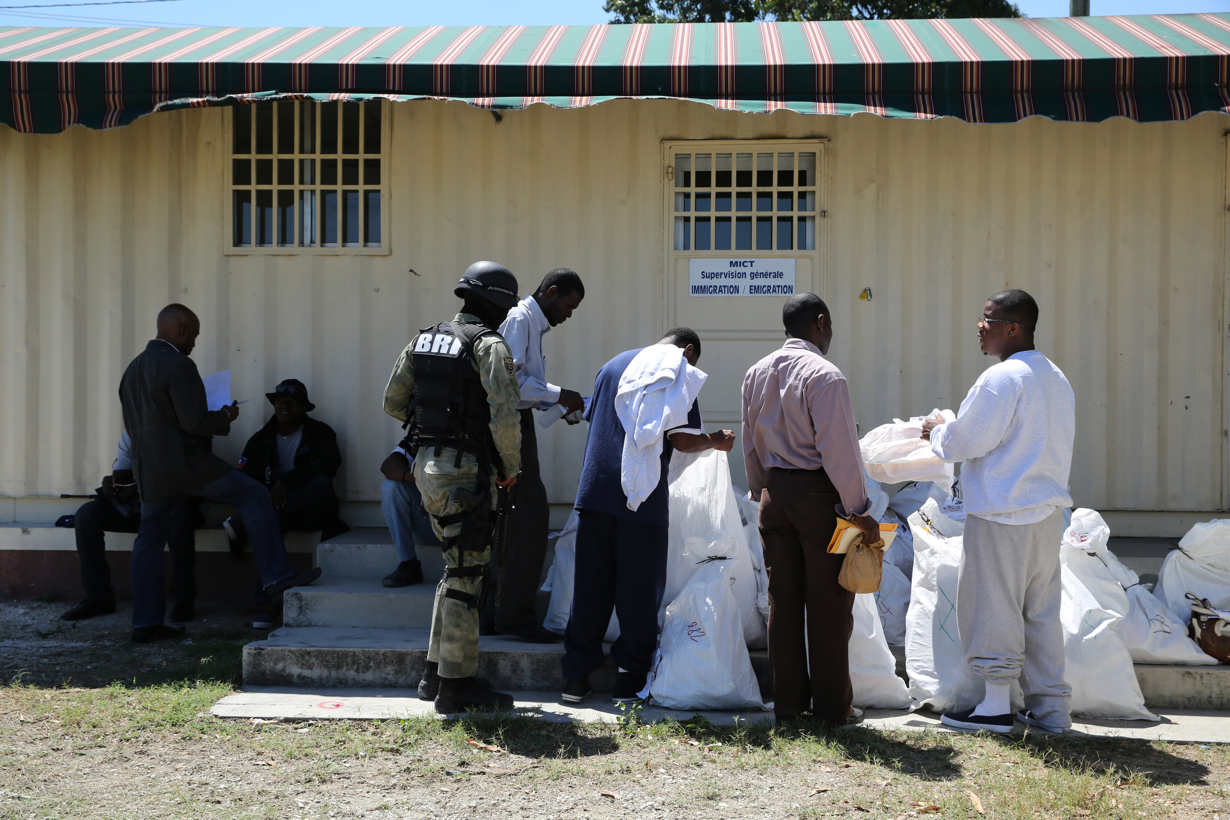   Deportees gather their belongings.  