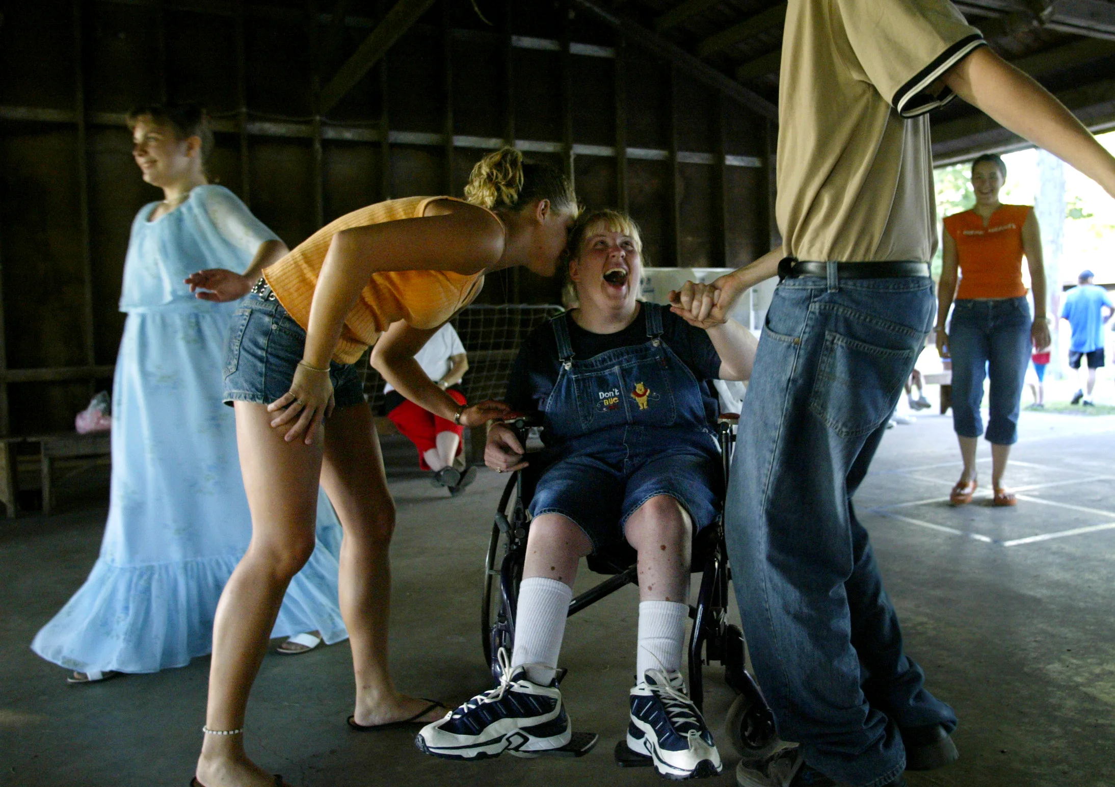  Camper Cherie Johnson (center) dances with &nbsp;counselors Josh Knott (right) and Rachel Seymour (second from left) at Camp Courage. Ms. Johnson has been attending the camp for children &amp; young adults with disabilities each summer for the past 