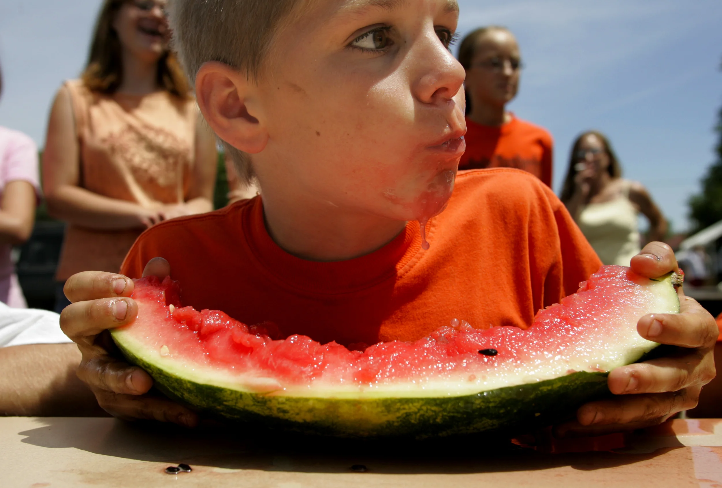  A young competitor pauses to check his competition during the watermelon eating contest as part of Meredosia's Fourth of July festivities. 