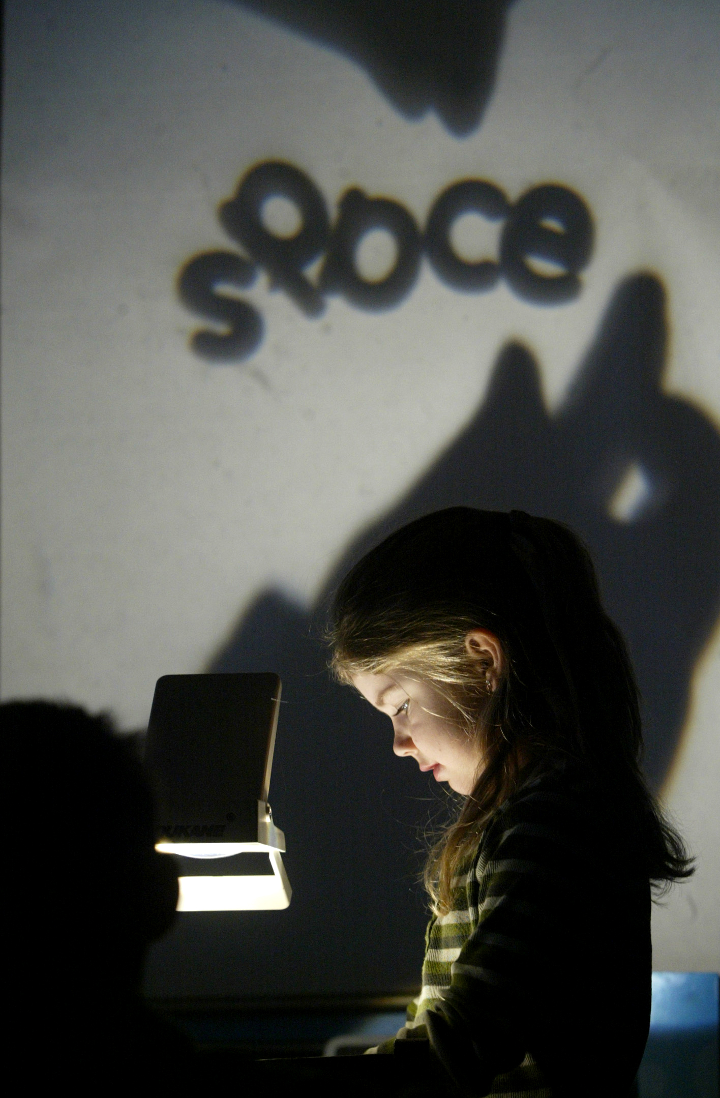  Bluffs Elementary School student Brianna Long arranges letters on an overhead projector to spell a word her first-grade teacher, Jennifer Taylor, has chosen. The exercise helps teach phonics — the application of sounds to letters. Bluffs School Dist