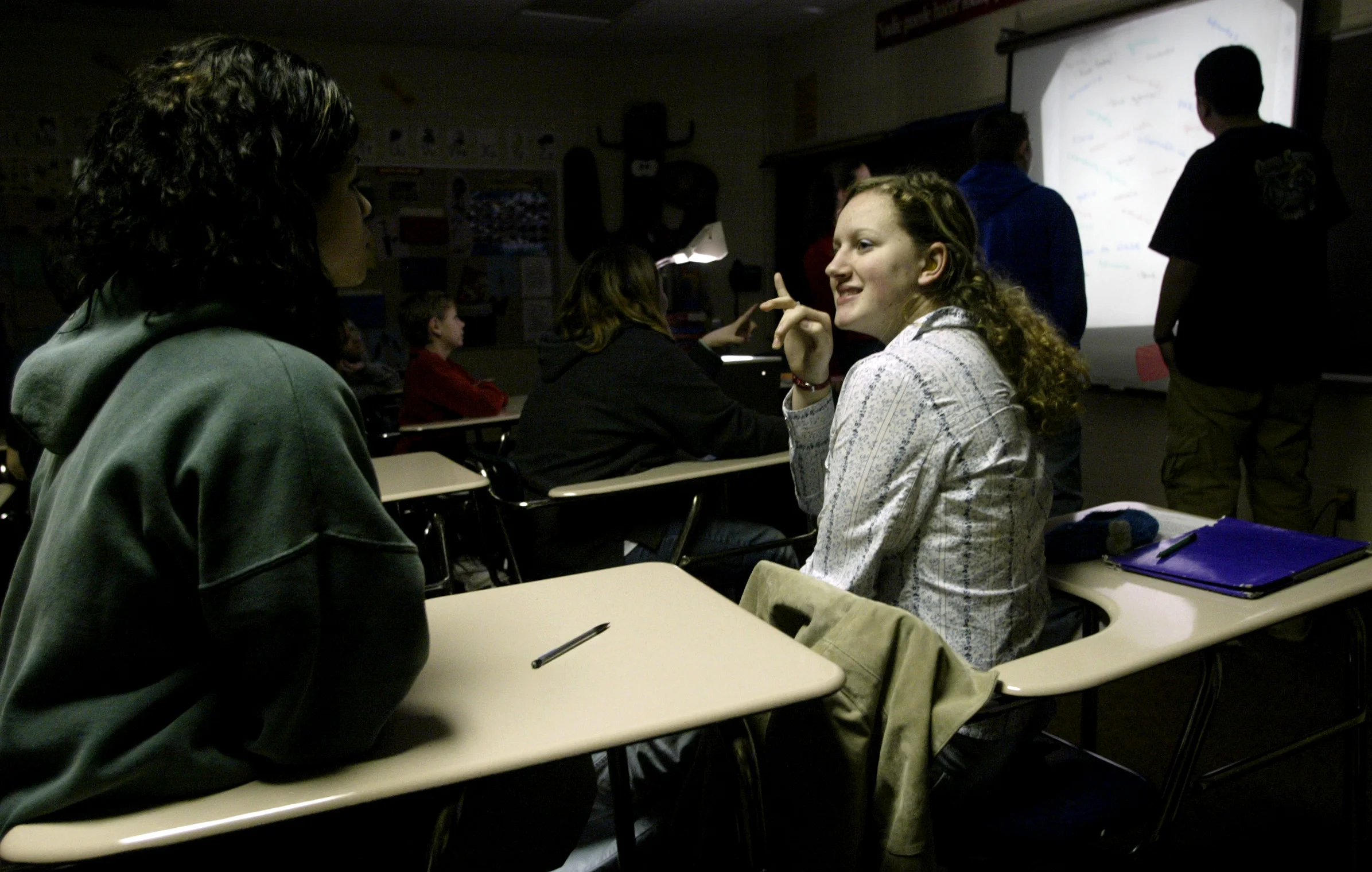  Illinois School for the Deaf student Krista Brown signs to fellow student Amanda Aillon recently during a Spanish I class at Jacksonville High School. Krista and Amanda, along with ISD student Barb Garard, are taking the Spanish class at JHS with he