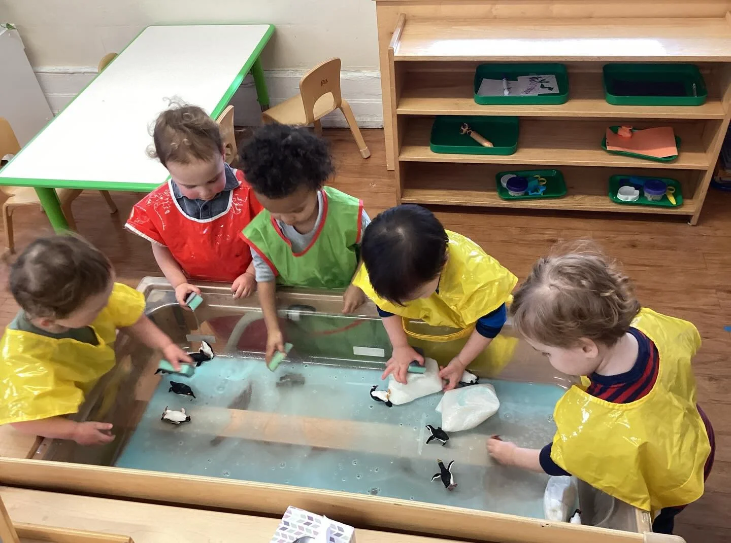 This week was all about penguins! Our toddler class made collage-style penguin art and at the sensory table, they enjoyed water play with icebergs and penguins. They also used their fine motor skills to melt arctic animals from blocks of ice. Our ear