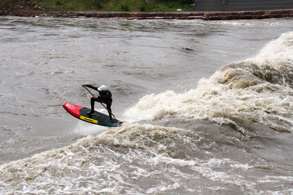 Zack Hughes, co-owner of Badfish Stand Up Paddle catching air on his 6'11" river surfer. 