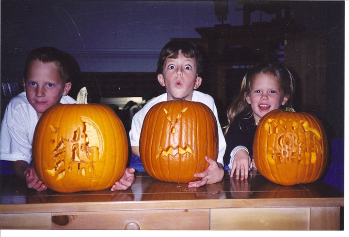 My kids on our favorite holiday! Carving pumpkins...not messy at all!
