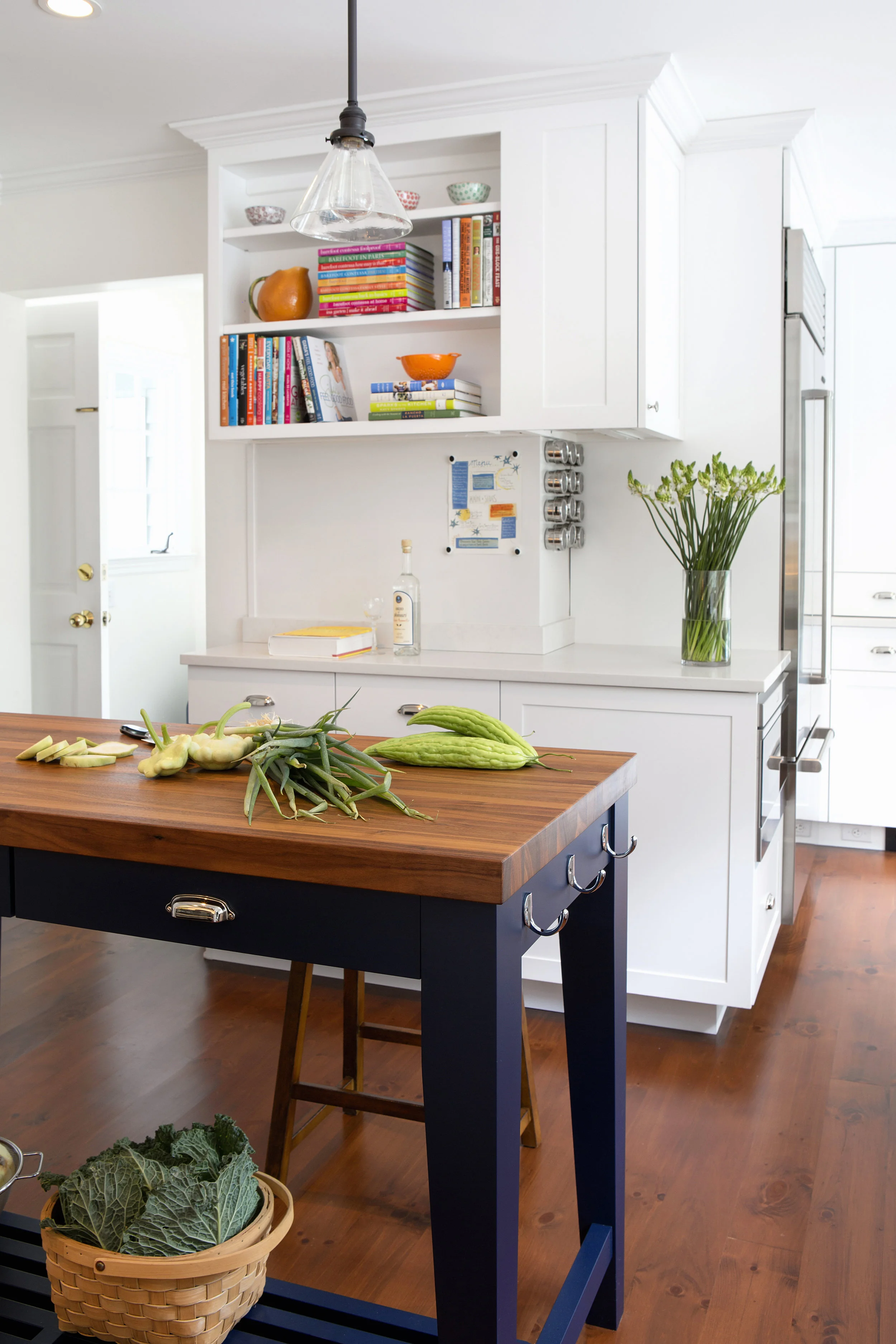 Hooks for dishtowels on one end of the island are one of many small details that make the space eminently livable.