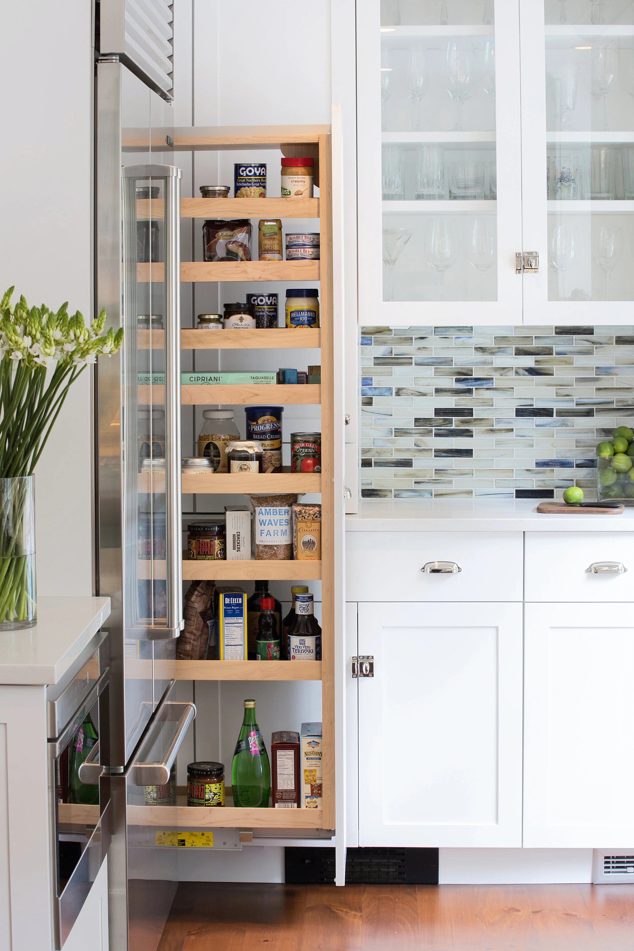 A narrow space between the refrigerator and back wall was big enough to house a pullout pantry.