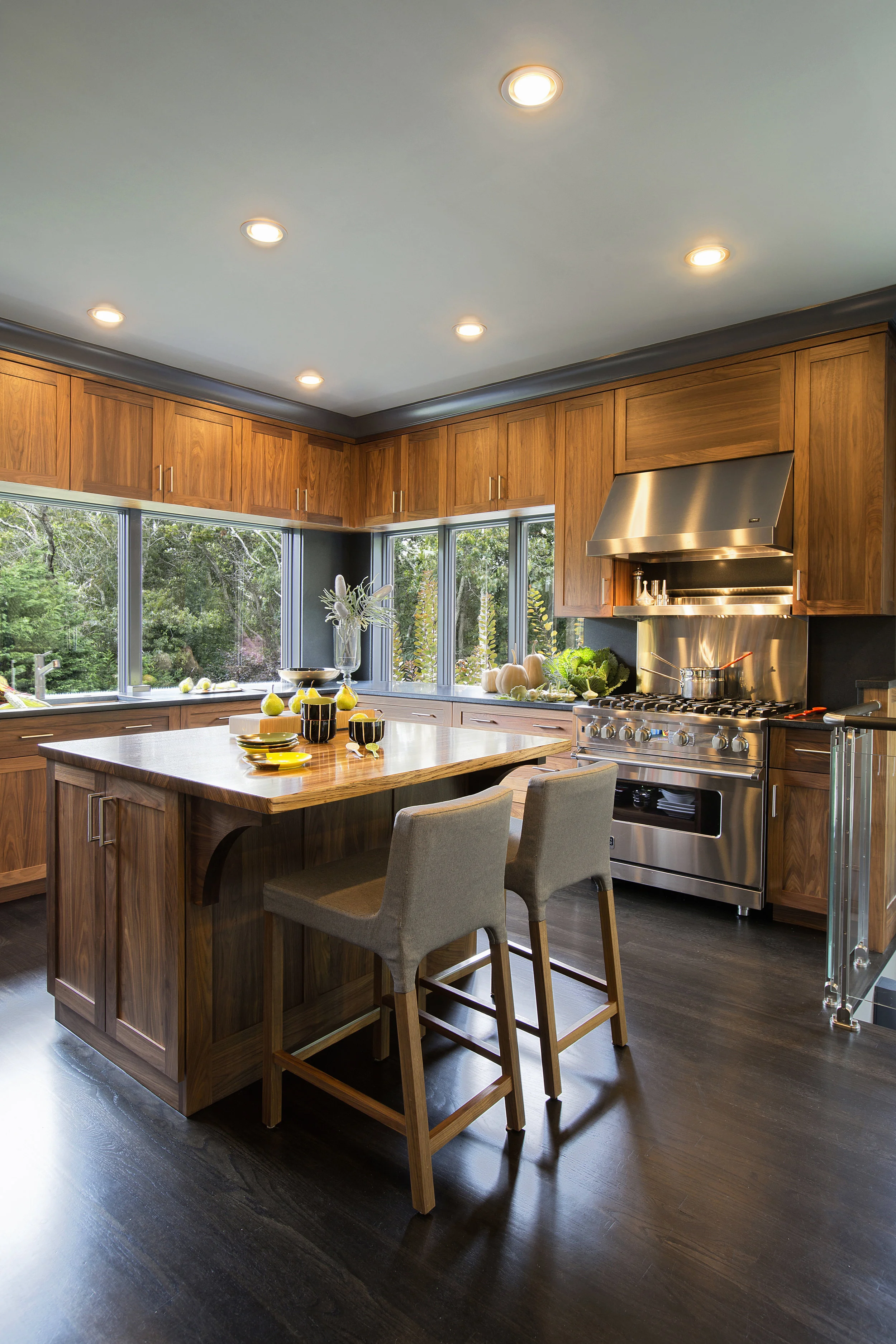 Custom walnut cabinetry serves as a rich, warm setting for gleaming stainless appliances.