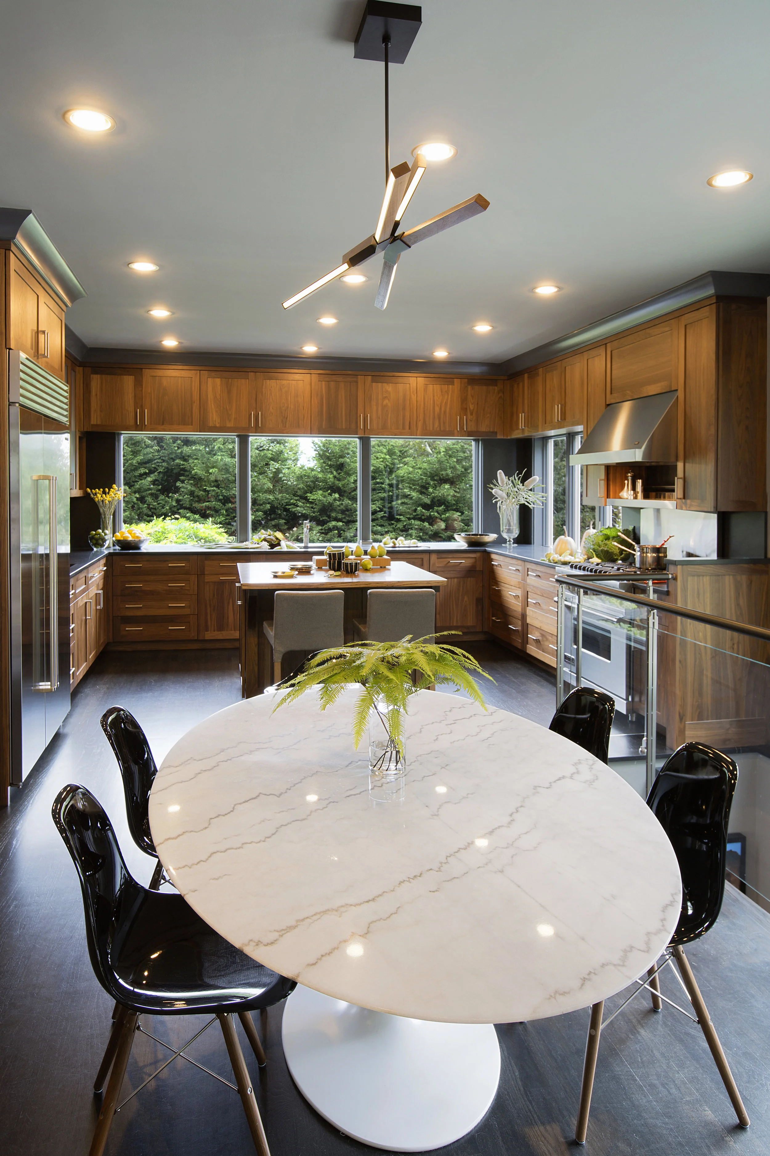 The kitchen is open to the breakfast room, so everyone can join in. The client had already purchased the marble table and chairs, so incorporating them into the space was an important part of the design,