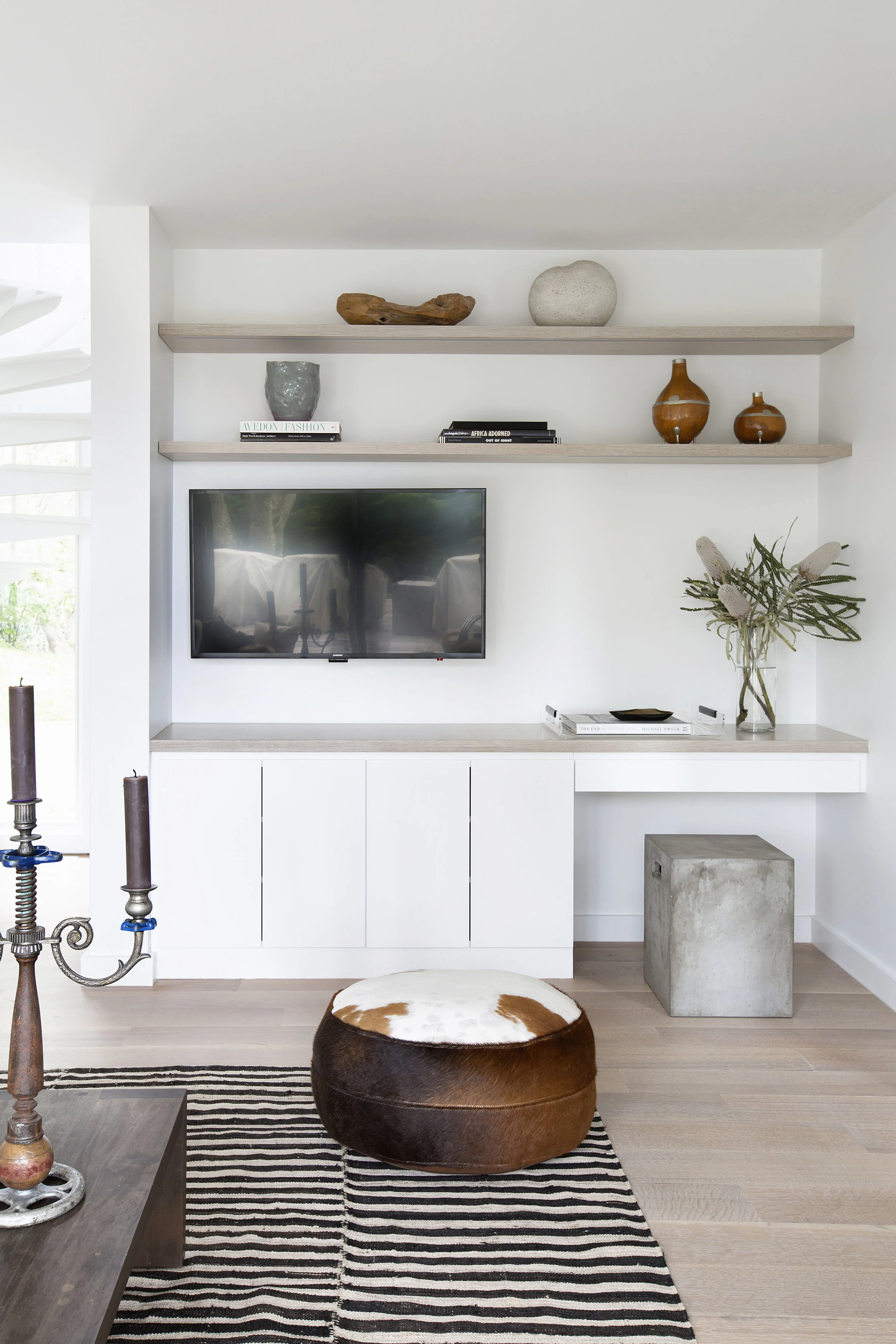 The same clean-lined, simple white cabinetry as in the kitchen carries over into the family room. The flooring is whitewashed oak, just like the office.