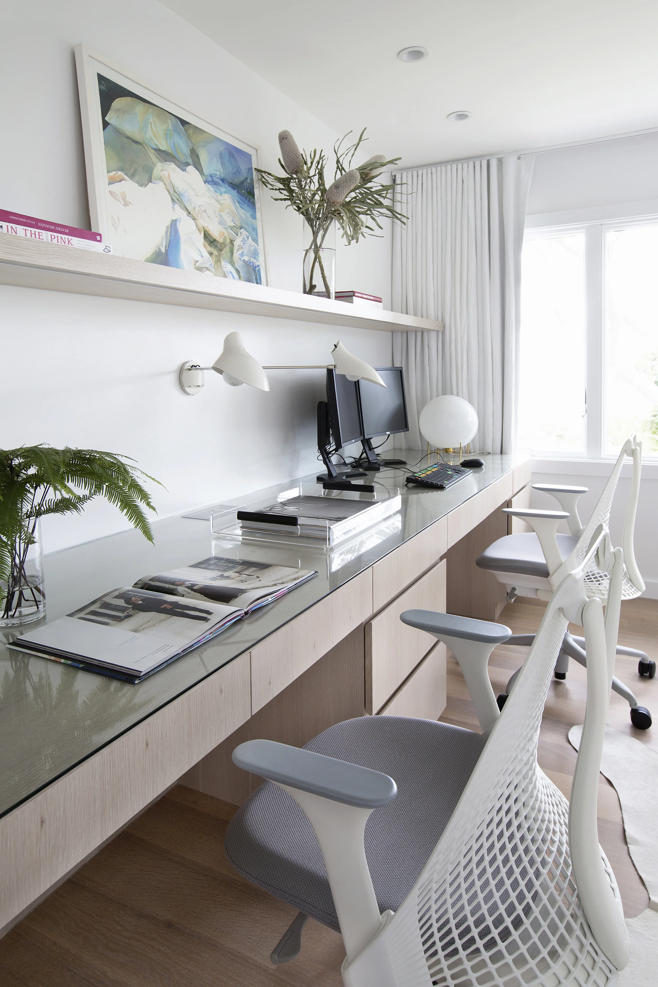 A single piece of glass protects the desktop and makes for easy cleaning. Channel finger pulls in drawers eliminate the need for hardware