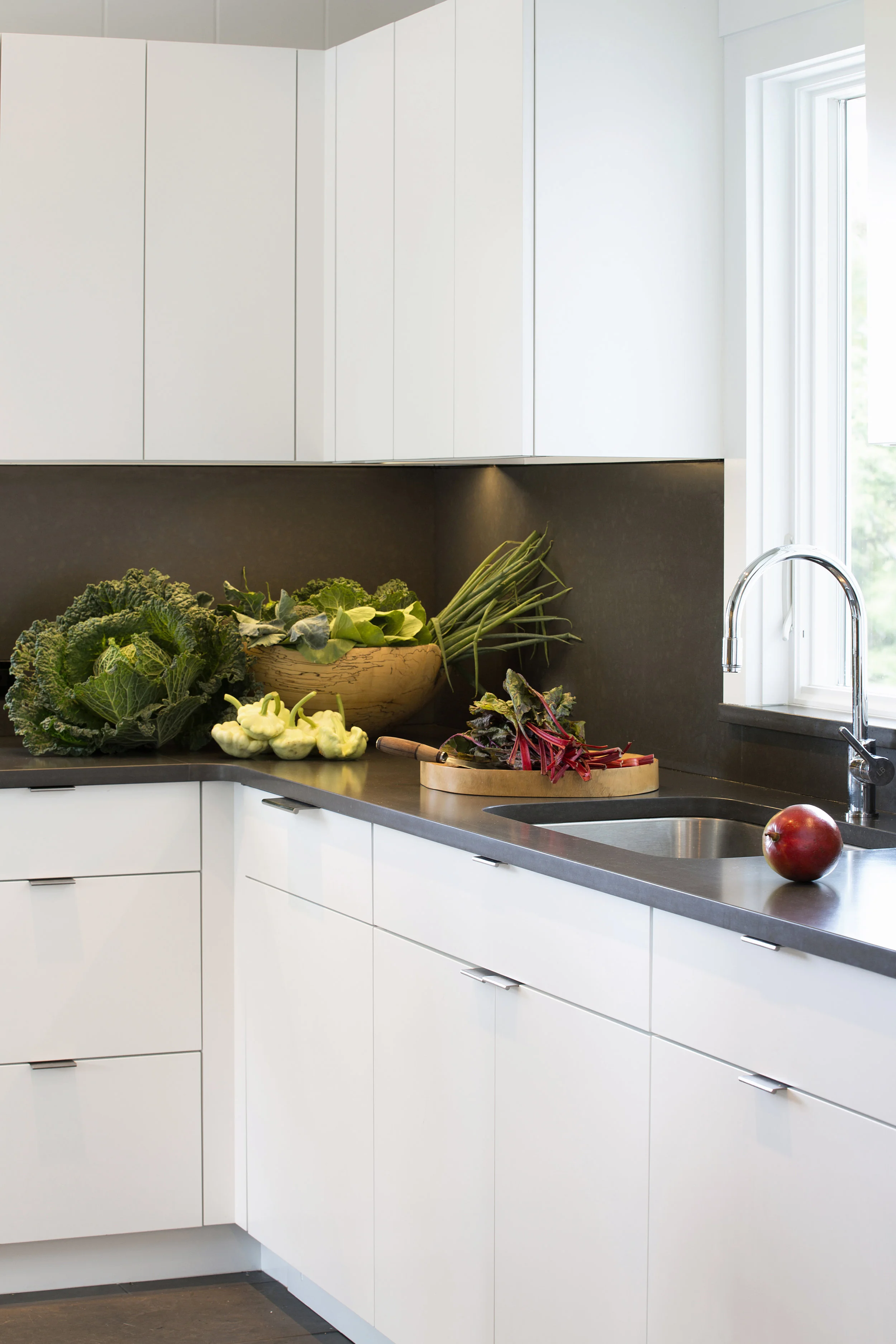 White cabinetry with edge pull hardware provides a minimum of fuss