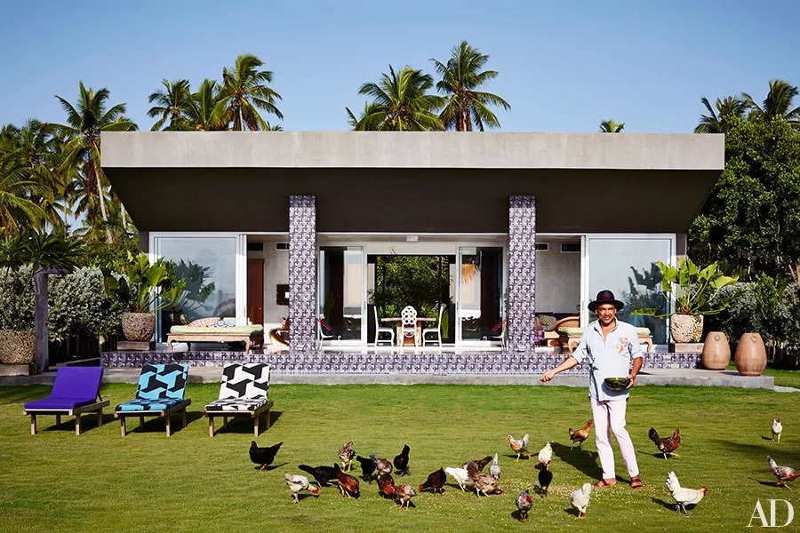 Carlos Mota feeding his chickens.