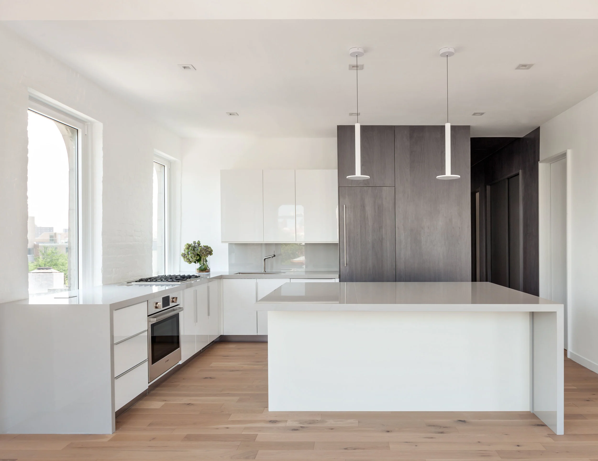 Kitchen finishes play with textures and shades of gray.
