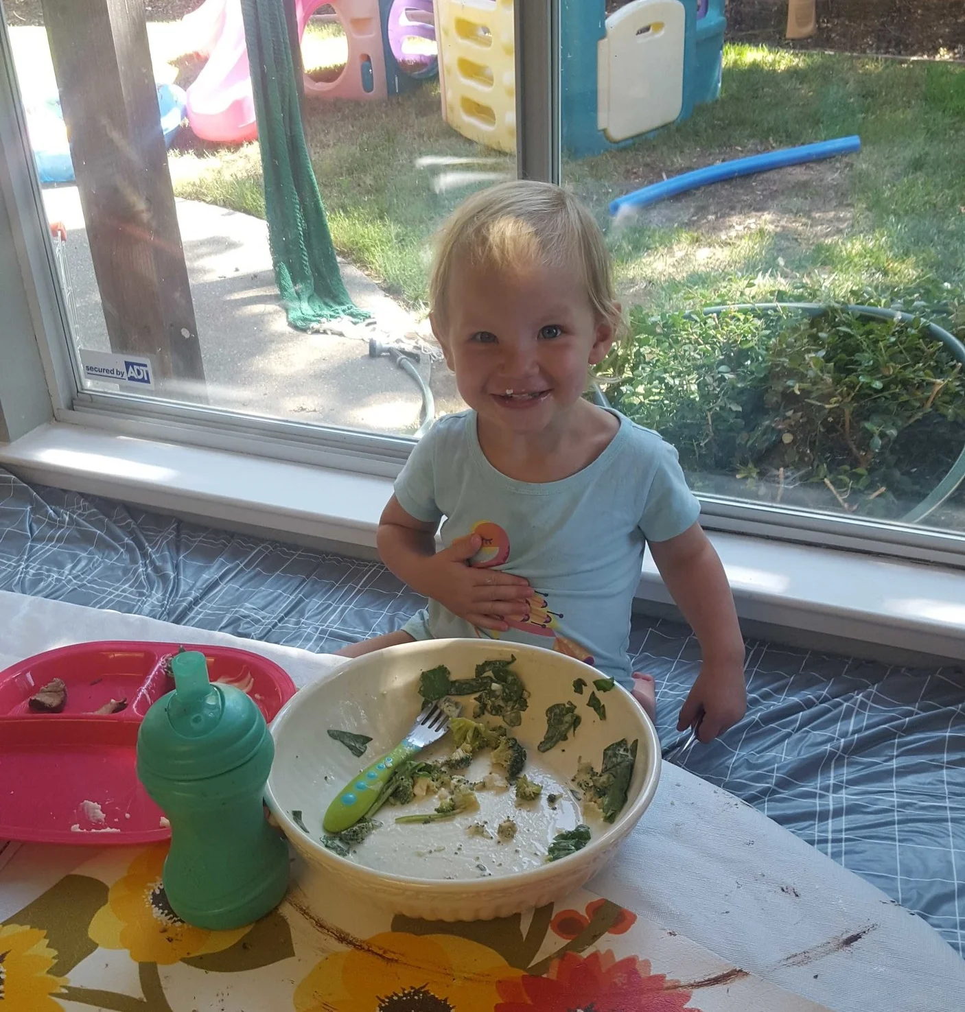 Madeleine enjoying her lunch of spinach and broccoli.