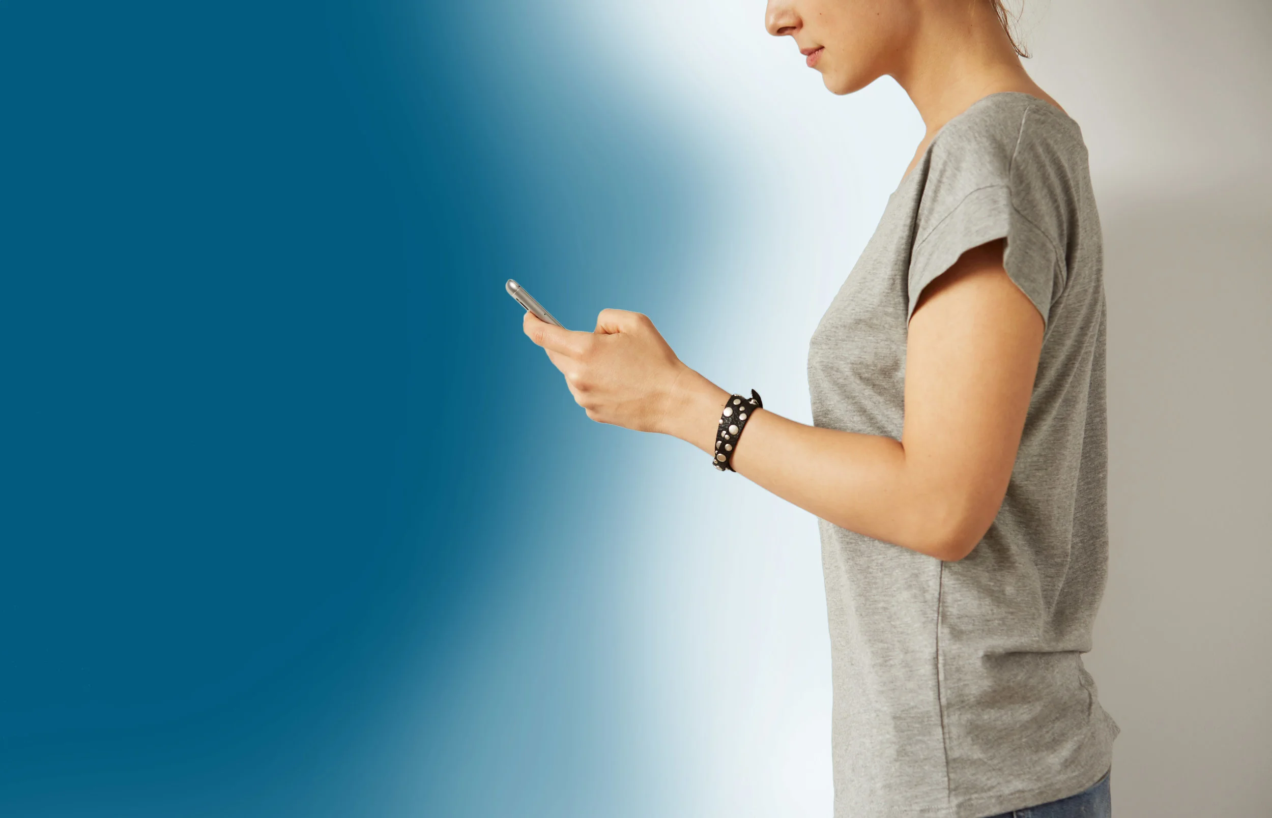 Woman on cell phone Blue BG AdobeStock_106362850.jpg