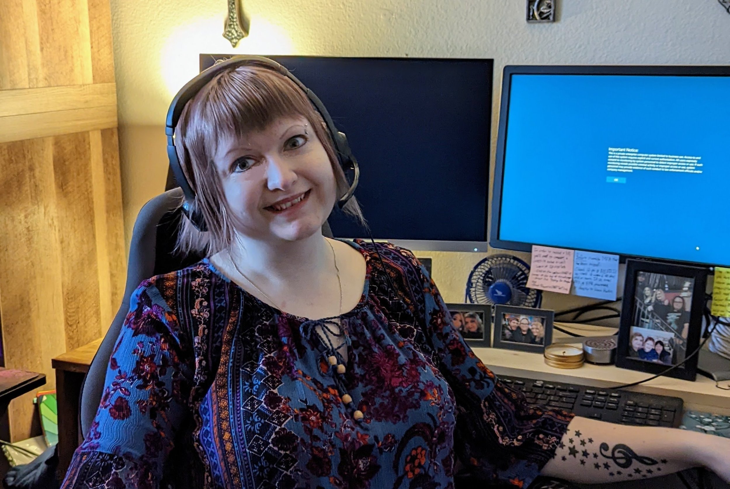 Rachel Putnam, UFCW 3000 member and Pharmacy Tech, is pictured sitting at her desk in her home office; she is wearing a headset.