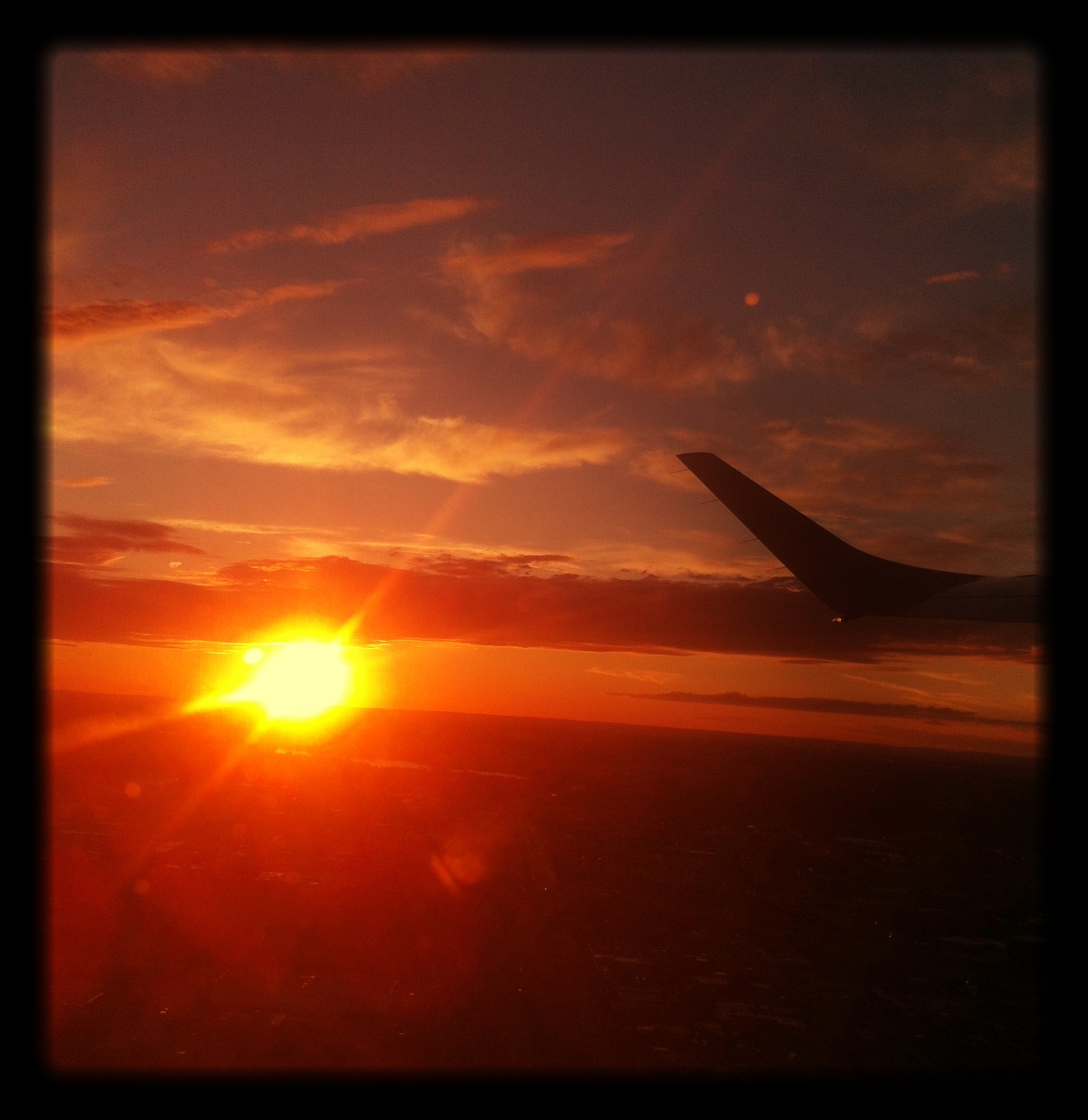 View_through_the_window_of_a_plane_during_sunset