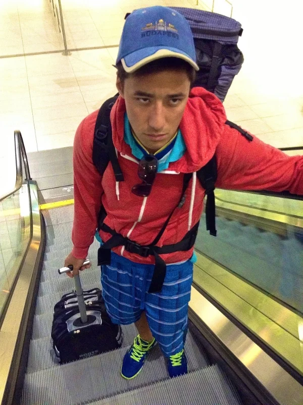 My boyfriend carrying my bag and rolling his… he's not too happy about it!!