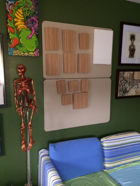 These cork boards over the sofa are were I will post work in progress. Right now they are home to the bamboo panels I purchased from the Portland, Oregon based company, Plywerk . Soon they will be paintings! You can also see that my skeleton, Roger, is right at home in the new space below the work by Scarecrowoven ! I have moved a good amount of our acquired art collection to the studio so I can be inspired by my fellow artists as I create new works in my new amazing space!