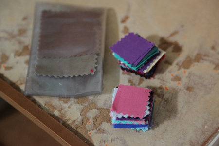 I had wanted to make a mini quilt for the bed and found these delicate fabric samples at Goodwill, and cut them into small squares.