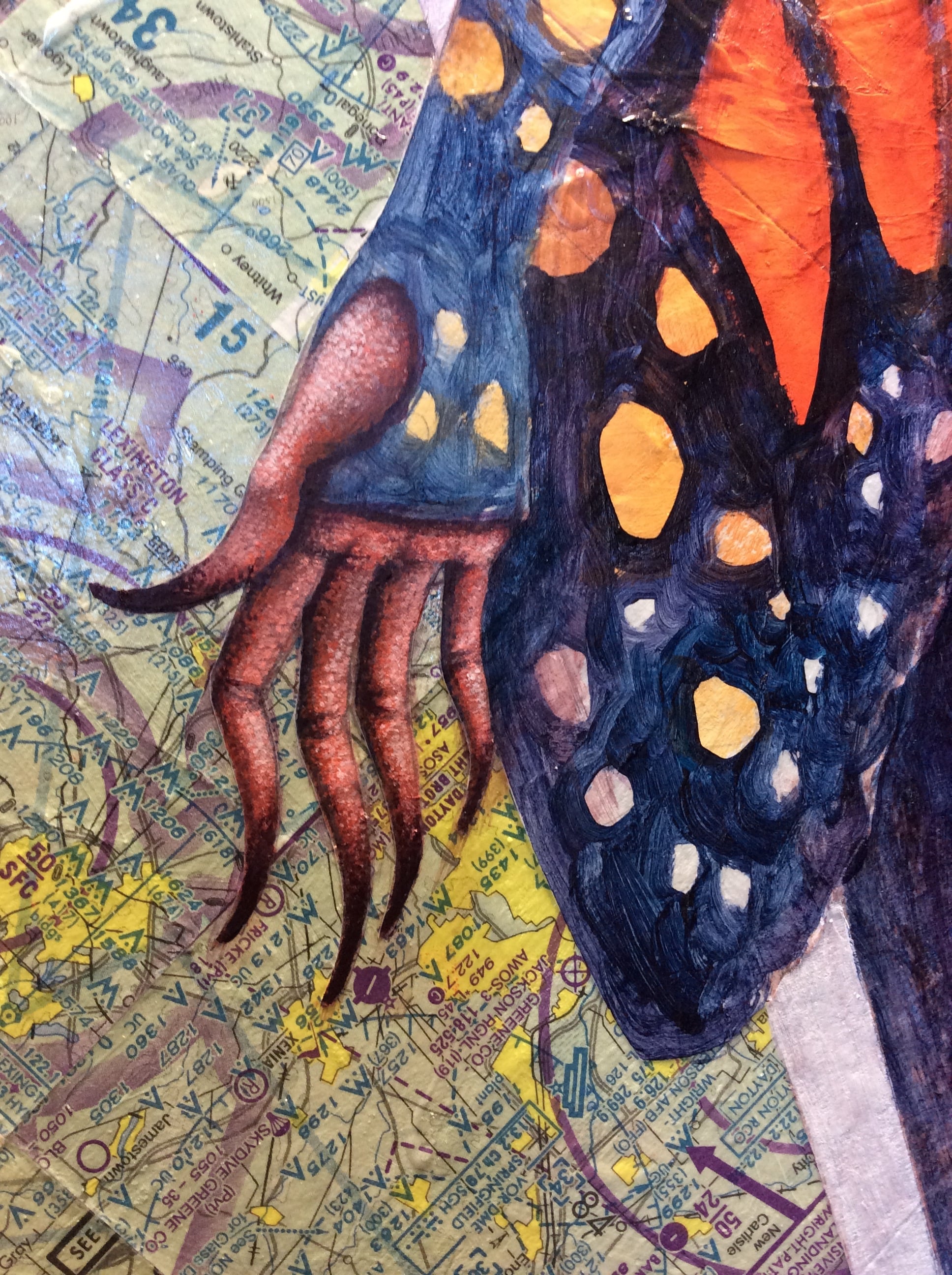 A detail of the hands in progress and the maps. 