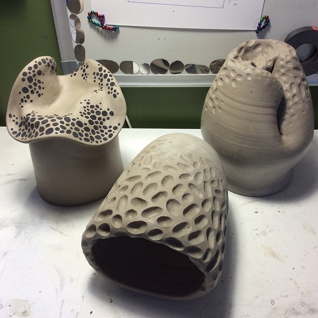 The black pebble/dots are a glaze. These vessels are ready for the Raku firing. Back to Bruce...