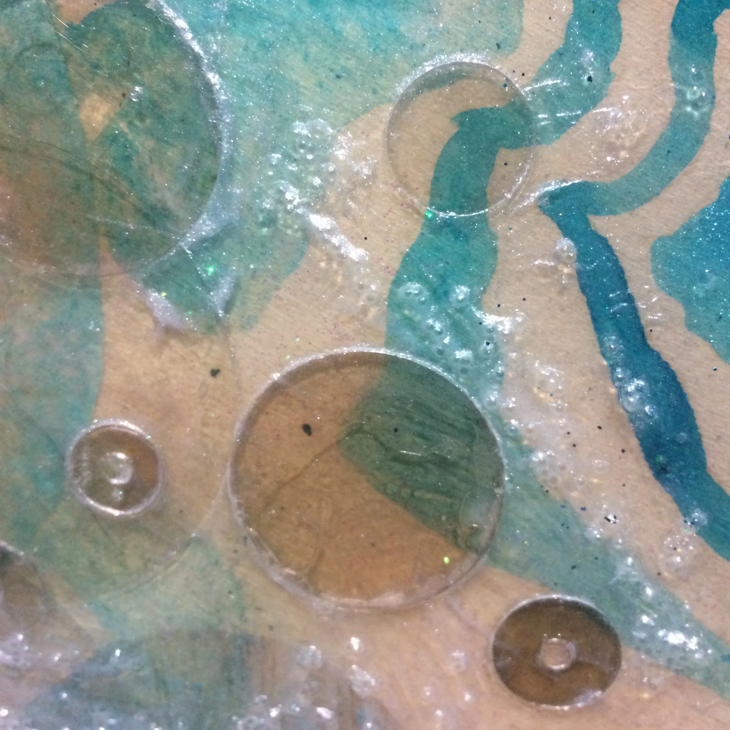 Detail of acrylic wash, mica, pouring medium, glass beads and some iridescent medium. 