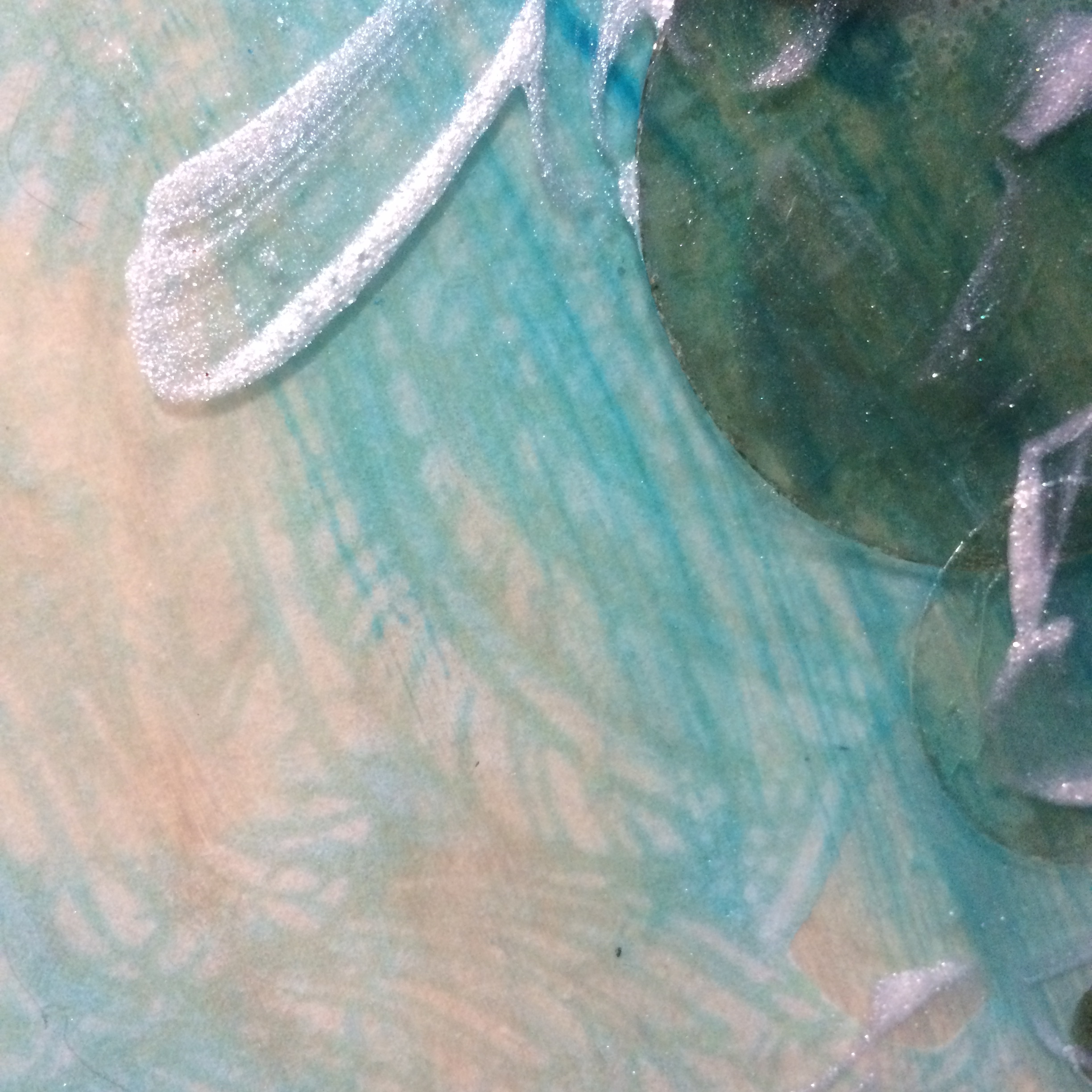A hint of feathers and another layer with iridescent medium. 