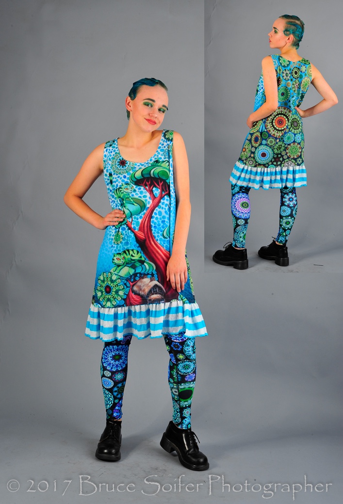 Ashley is modeling my Cheshire Tank Dress. There are two of these available for purchase, so contact me if you would like one! The tank portion of the dress is dye sublimation printed of my Cheshire Tree painting and then I added the striped trim. The back is a gradient of kaleidoscopes. 