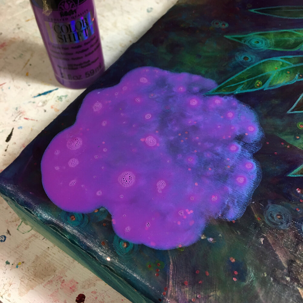 Making paint puddles, which is simply watered down paint. 