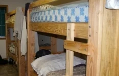 Old Wood Frame Bunk Beds that need to be replaced with metal frame bunk beds.