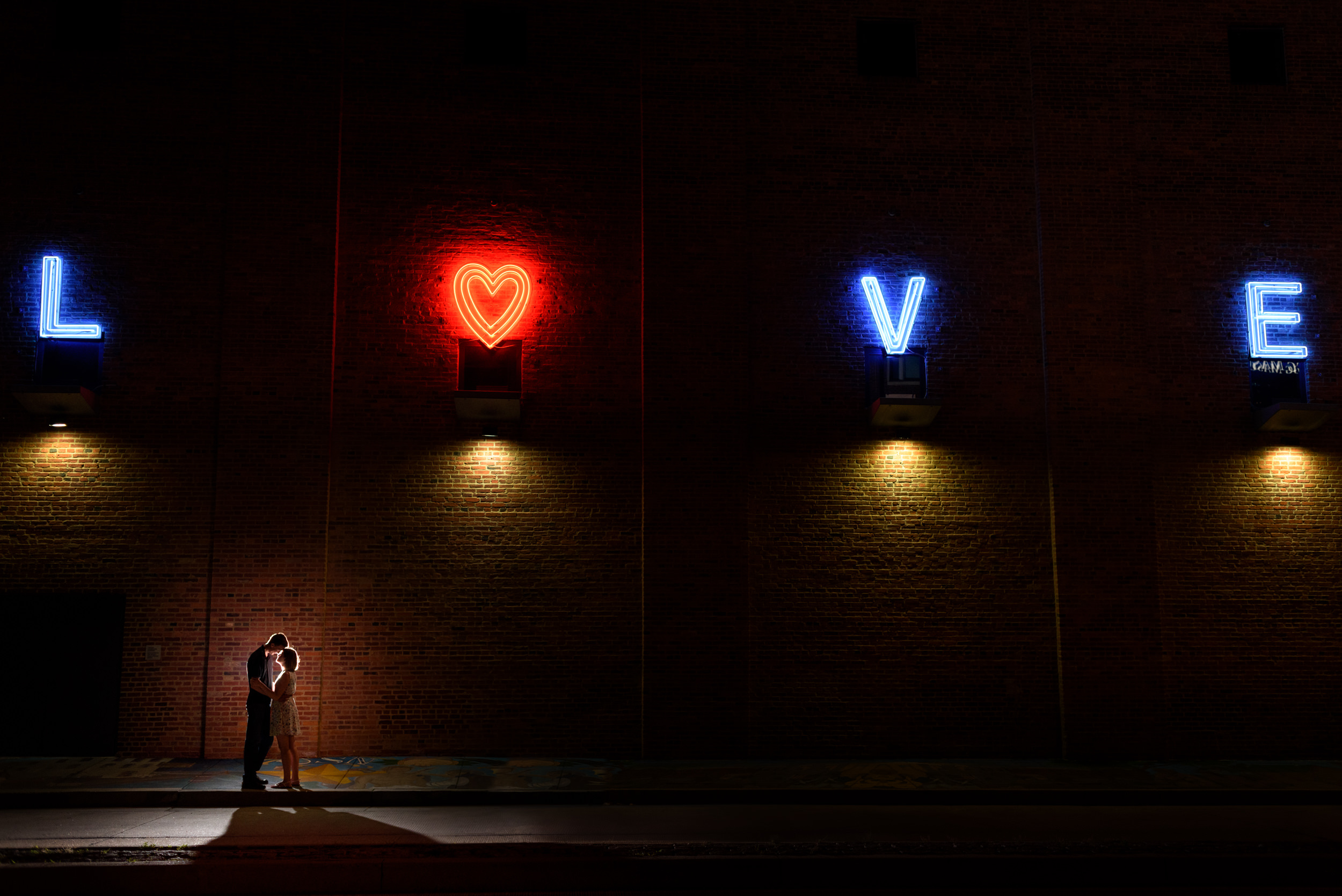 Silhouette portrait in front of the neon Love sign at the American Visionary Art Museum in Baltimore