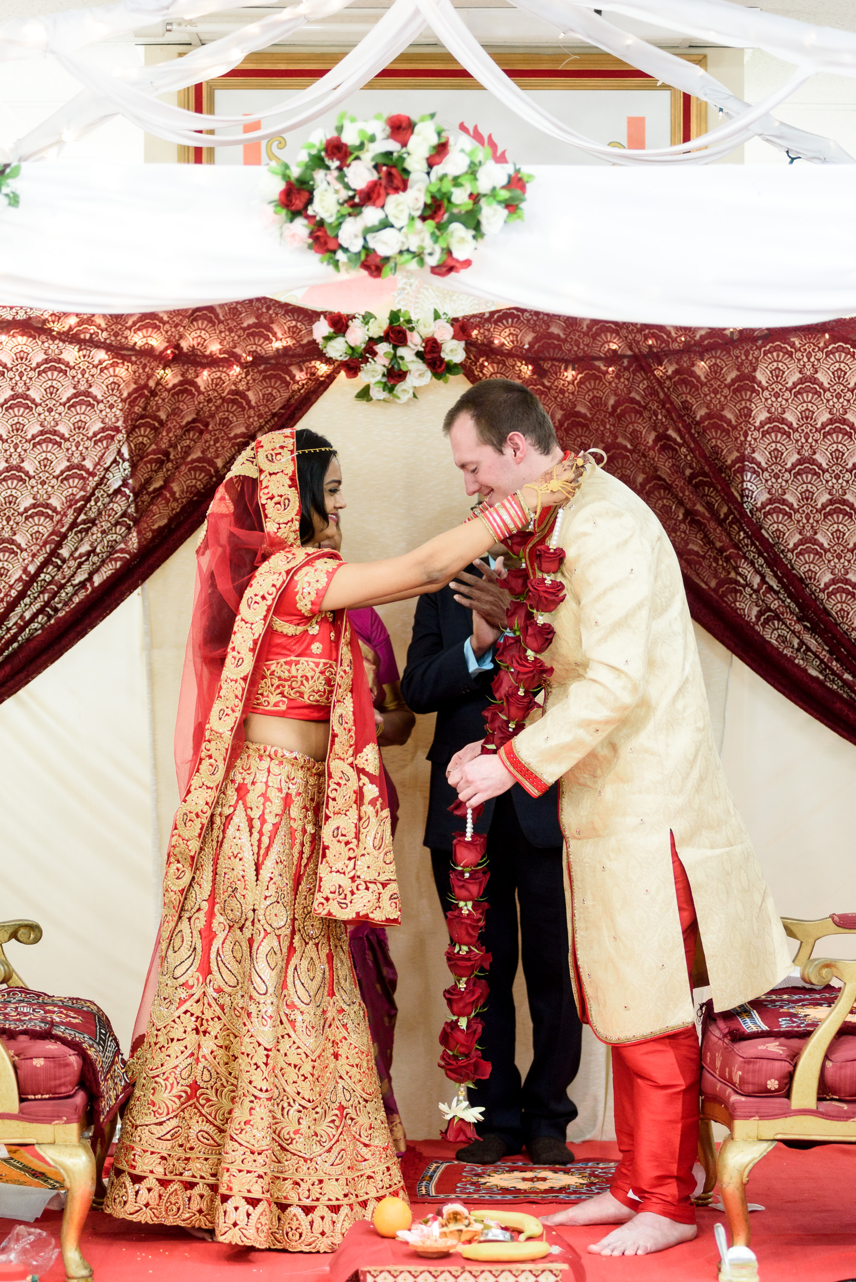 Bride and groom exchange flower garlands during Hindu wedding ceremony in Philadelphia 