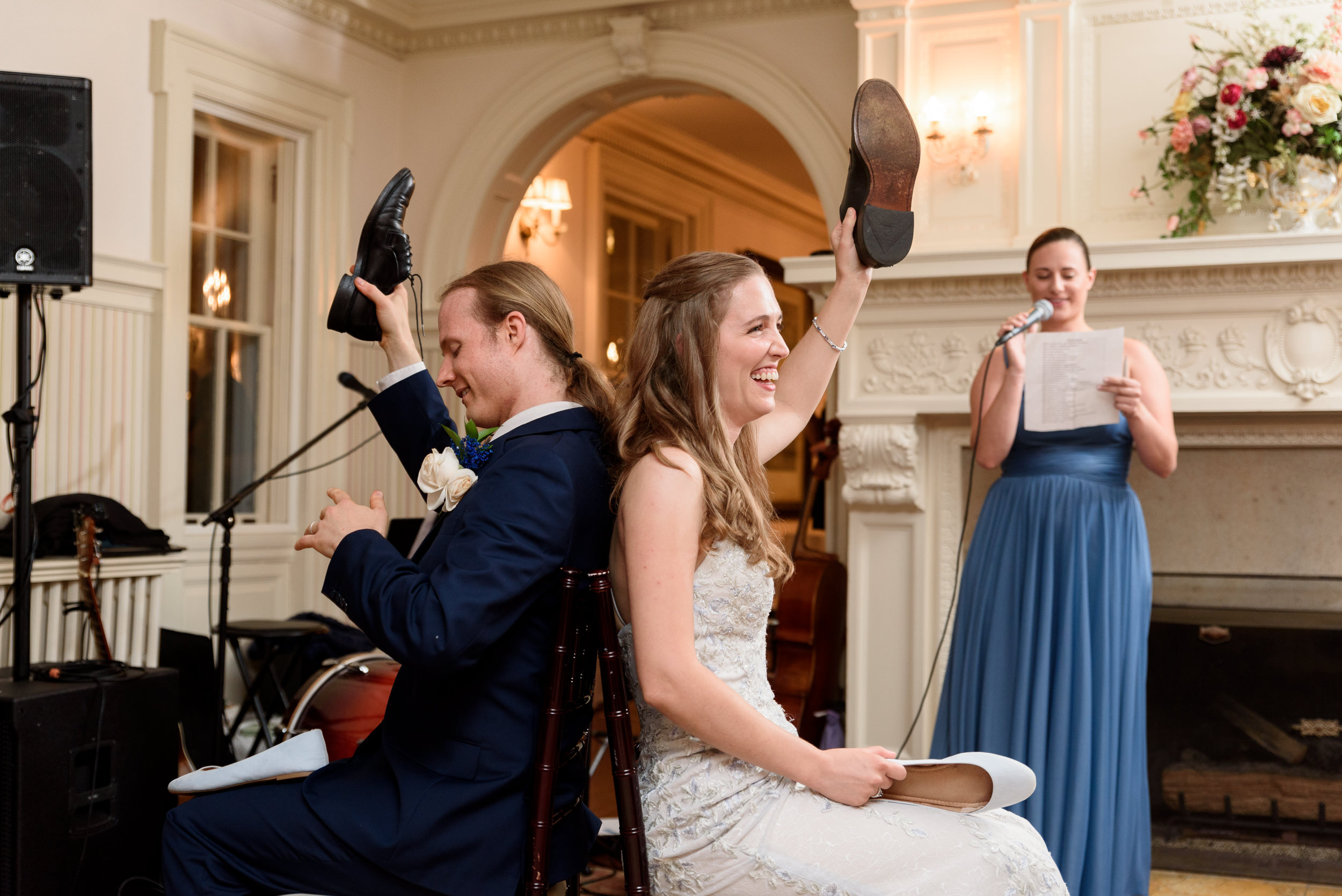 Bride and groom play the shoe game at Liriodendron Mansion wedding reception