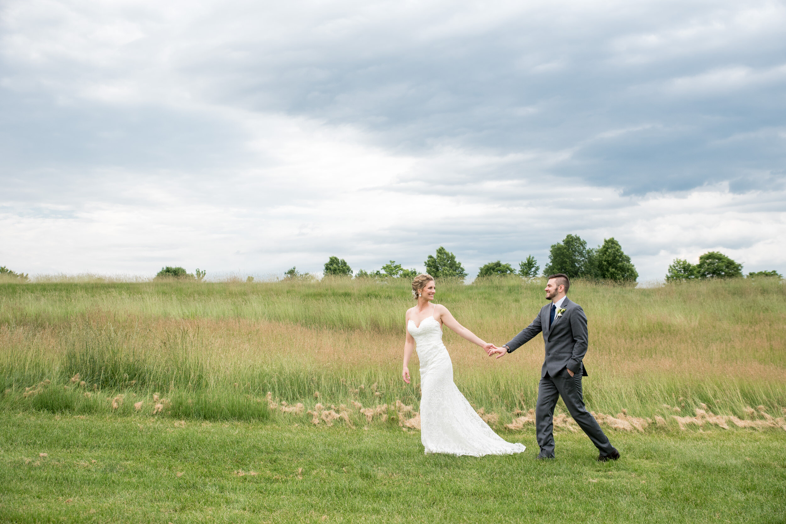 Bride and groom walking at Jericho National Golf Club