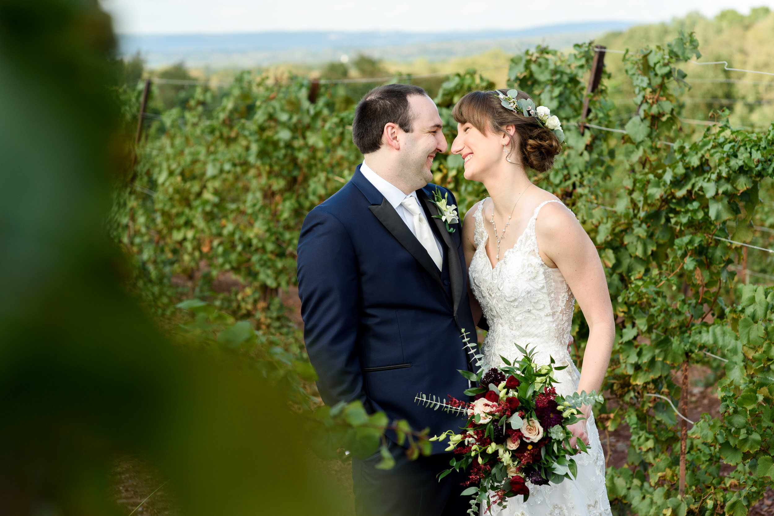 Bride and groom wedding photos in the vineyards at Sand Castle Winery 