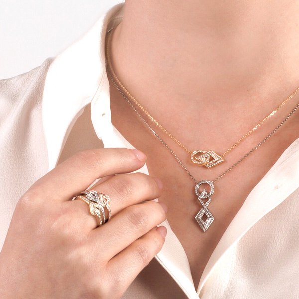 Layered pendants and rings in white and yellow gold and pave set with diamonds from Gararrard's new 24 Collection.