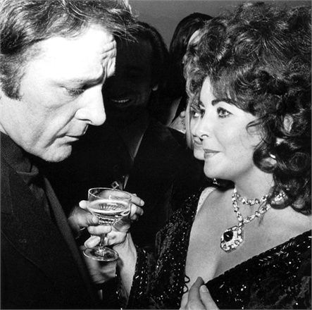 Elizabeth Taylor with Richard Burton looking impossibly glamorous, wearing her sapphire and diamond sautoir.