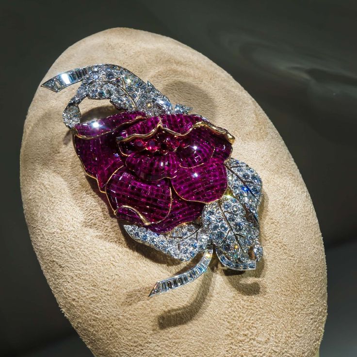 A mystery set ruby and diamond peony clip by Van Cleef and Arpels.
