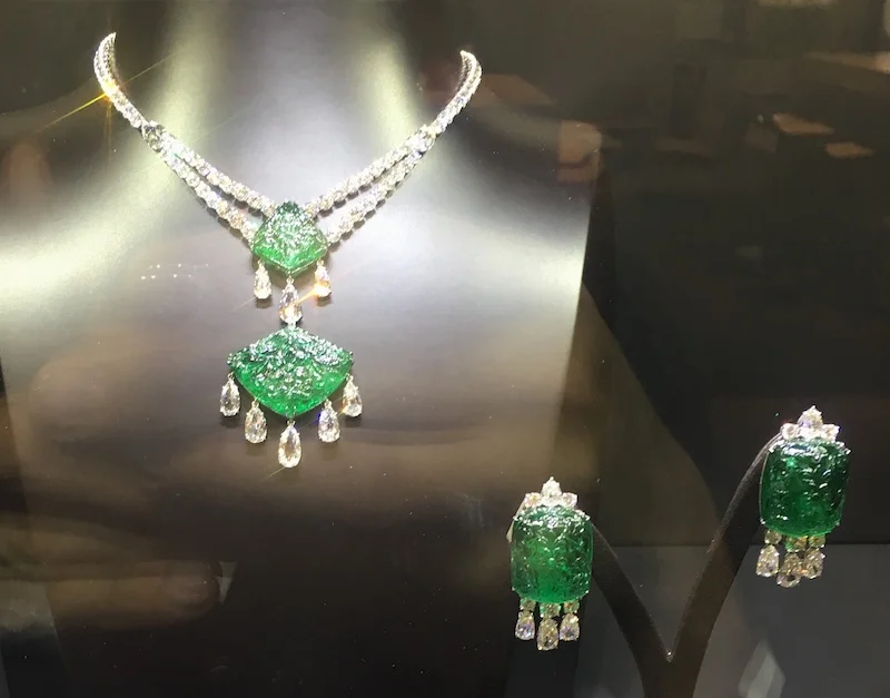 Carved gemstones are making a comeback as exemplified in this emerald and diamond set by Bayco.