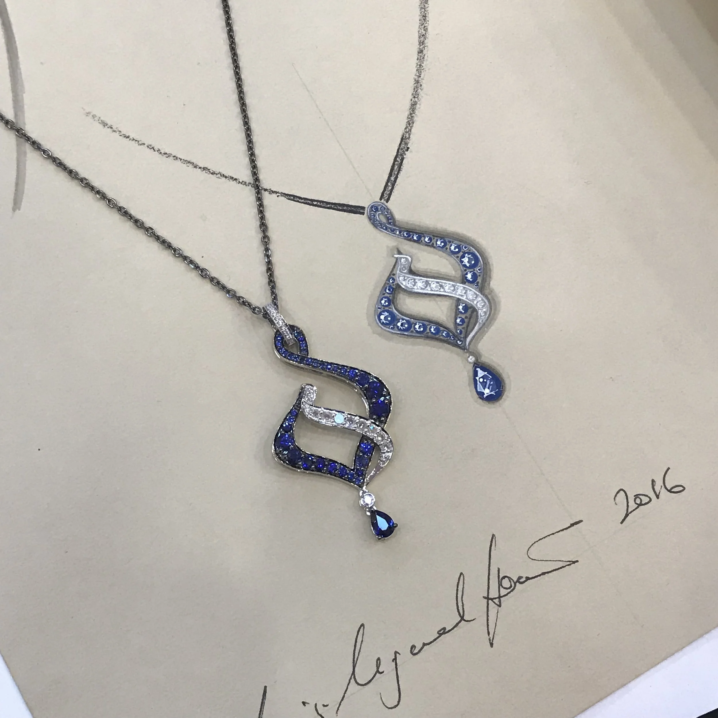 ‘Blue Flame’ pendant; inspired by Art Nouveau architecture and set with sapphires and rose cut diamonds in black gold. Shown next to its original working drawing.