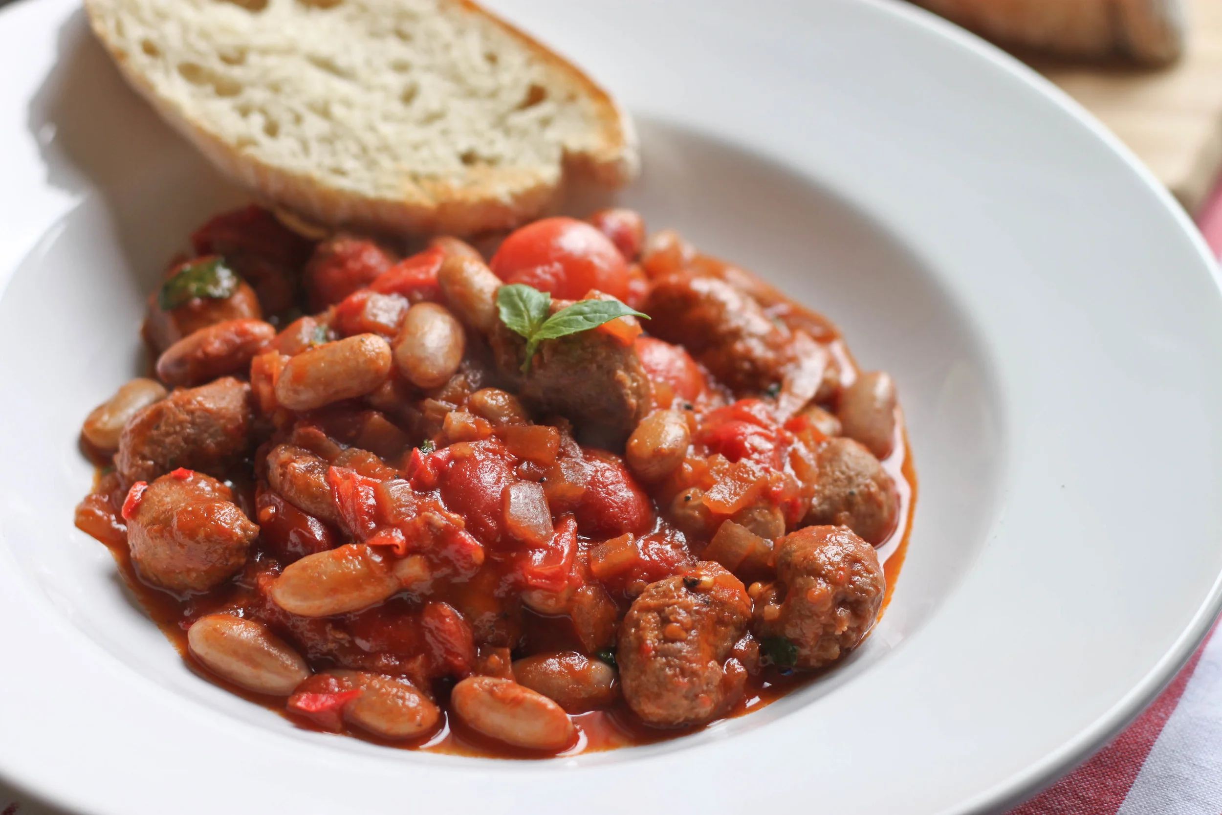 Sausage and berlotti bean stew recipe from icanhascook.com . The recipe is not vegan but all you need to do is switch the sausage for a vegan one!