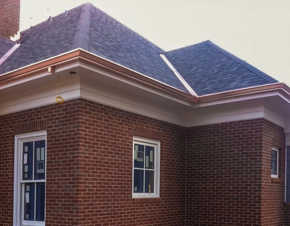 Copper box gutters and copper W valley, complement the installed CertainTeed Landmark Pro shingles.