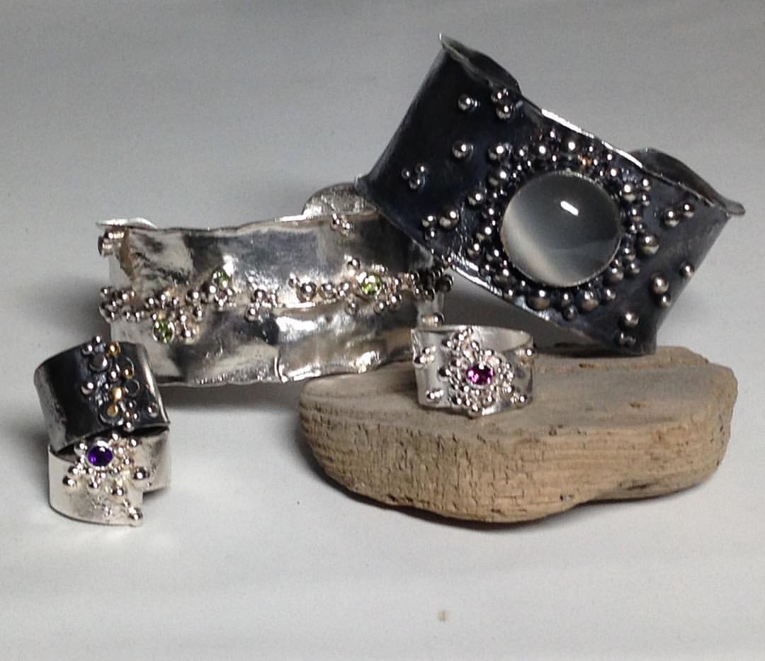 Reticulated silver bauble rings with amethyst, rhodolite garnet, and oxidized with 18k yellow gold. Reticulated silver cuff bracelets wave with 5 peridot gemstones and oxidized with large moonstone.